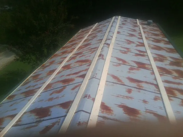Rusted metal roof panels with new wood purlins before replacement — Storm Damage Roof Repair in Wanatah by Roofing Brothers
