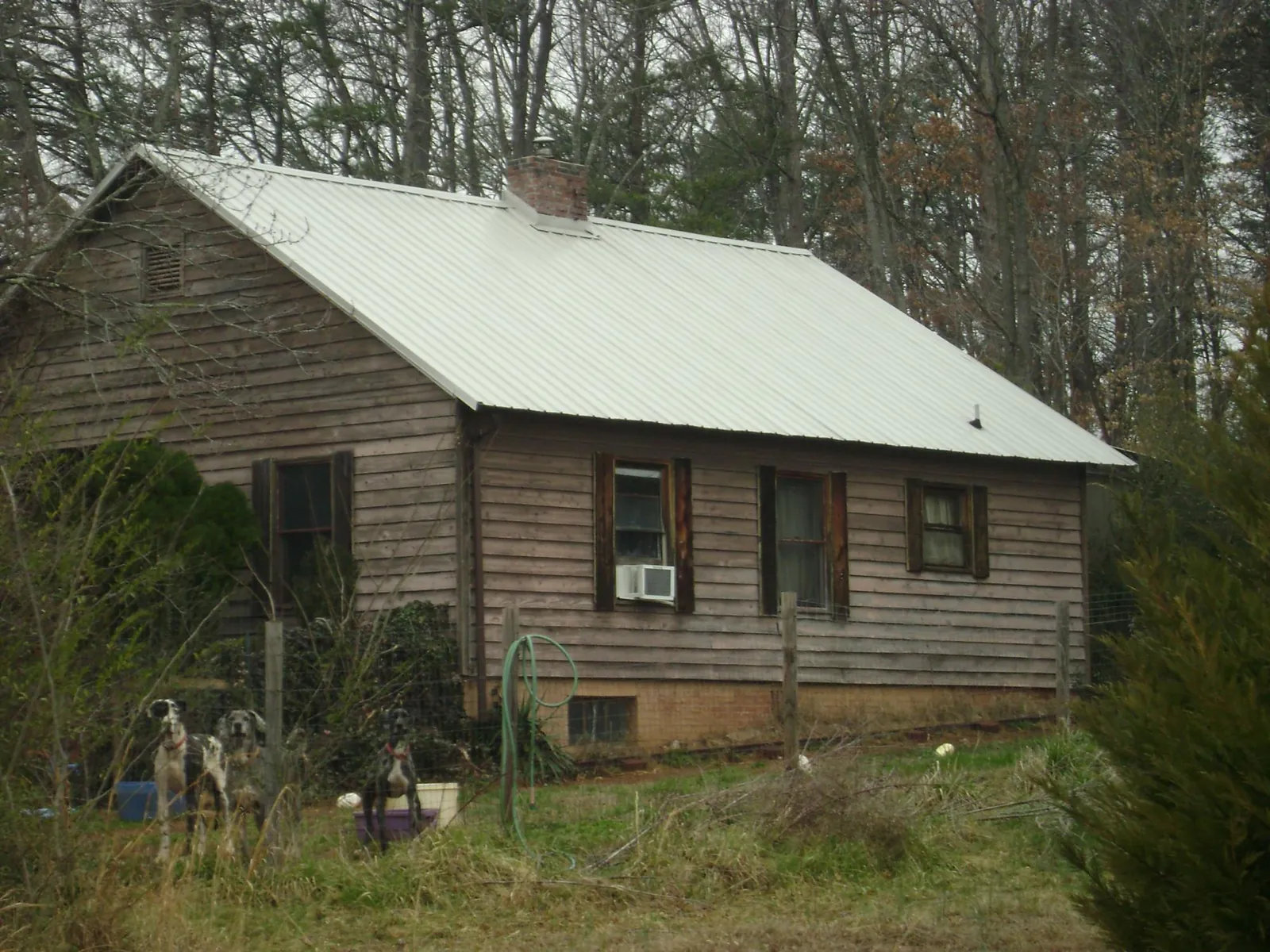 White metal roof on an old wood sided farmhouse, from a Metal Roof Installation job in Wanatah
